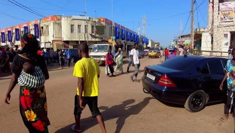 Tilt-up panorama of busy Serekunda Market street intersection