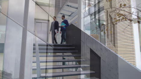 animation of office building over businessmen talking in modern office