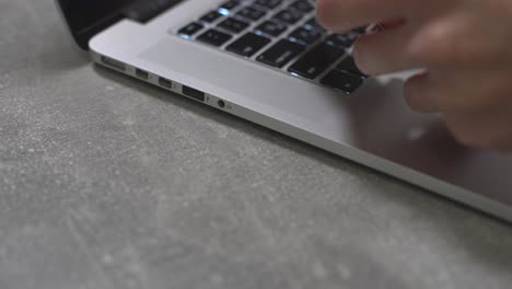 hands of cardholder holding credit card making e bank online payment. woman consumer paying for purchase in web store using laptop technology. ecommerce website payments concept. close up view