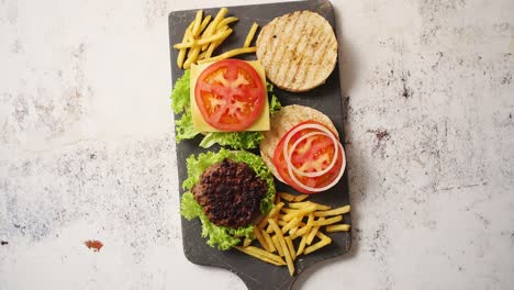 two tasty grilled home made burgers with beef  tomato  onion and lettuce