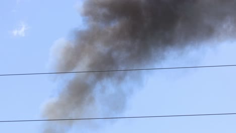 continuous black smoke from industrial chimney