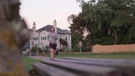 young athletic man goes for a run in the park, in slow motion