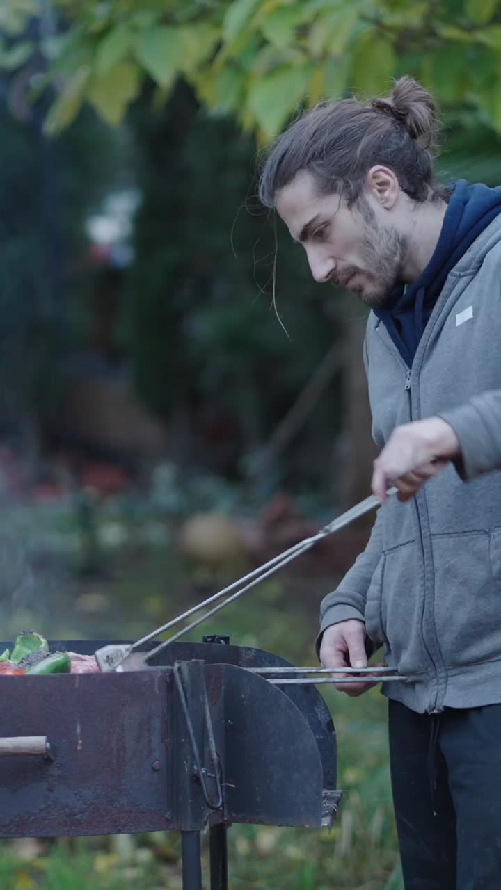 Man Grilling Food Outdoors