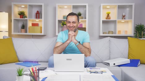 home office worker man makes a trust sign to the camera.