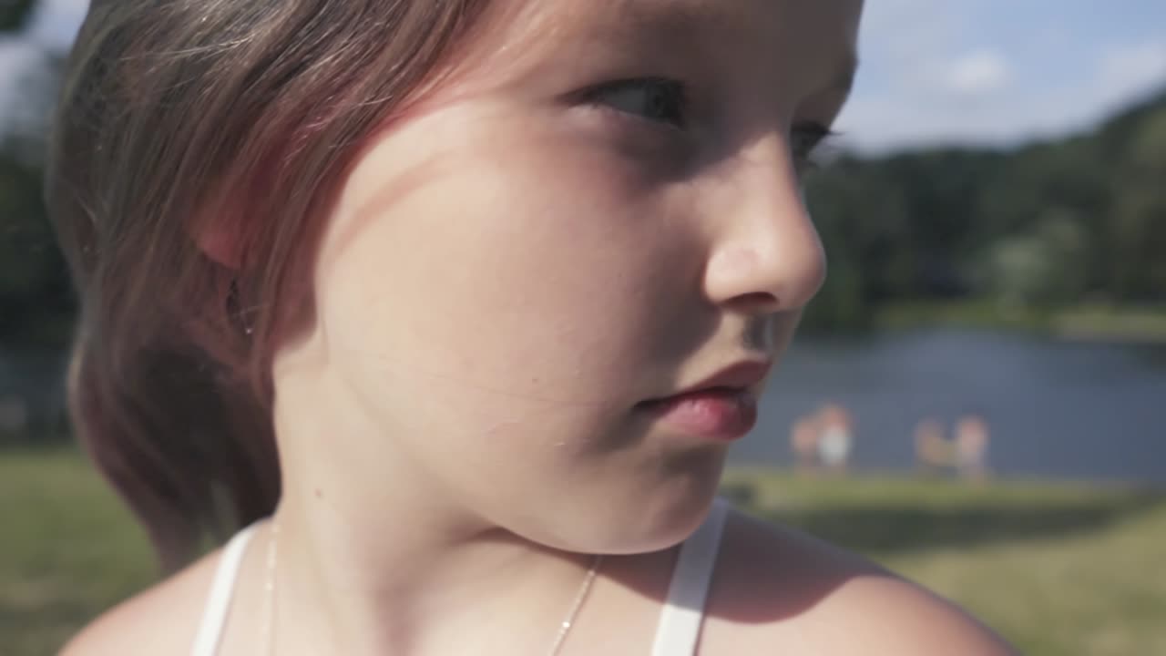Slow motion shot of the girl's face turning her head to the right