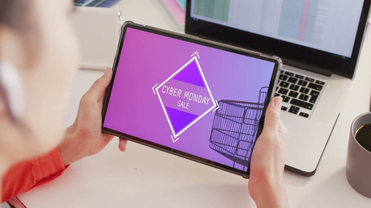 Caucasian woman at desk using tablet, online shopping on cyber monday, slow motion