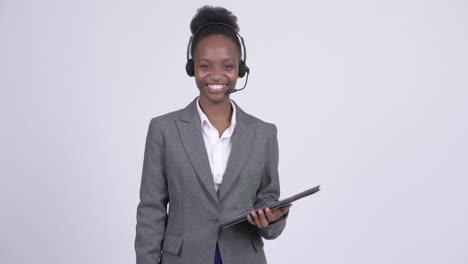 young beautiful african businesswoman as call center representative with digital tablet