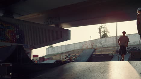 Sporty-teens-practicing-together-with-at-skatepark.-Friends-activity-exercising