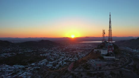 drone flies in front of a mountain exactly when the sun comes up