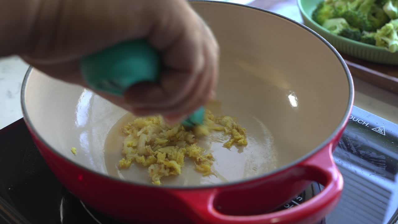 Adding Ginger and Oil to a Pot for Cooking