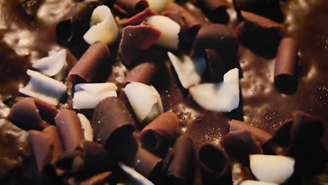 abstract blurred background shot of rotating cake close up of grated black and white chocolate