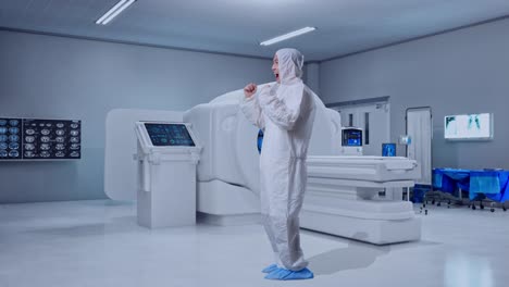 full body side view of asian male scientist celebrating the succeed while standing with mri machine in the hospital