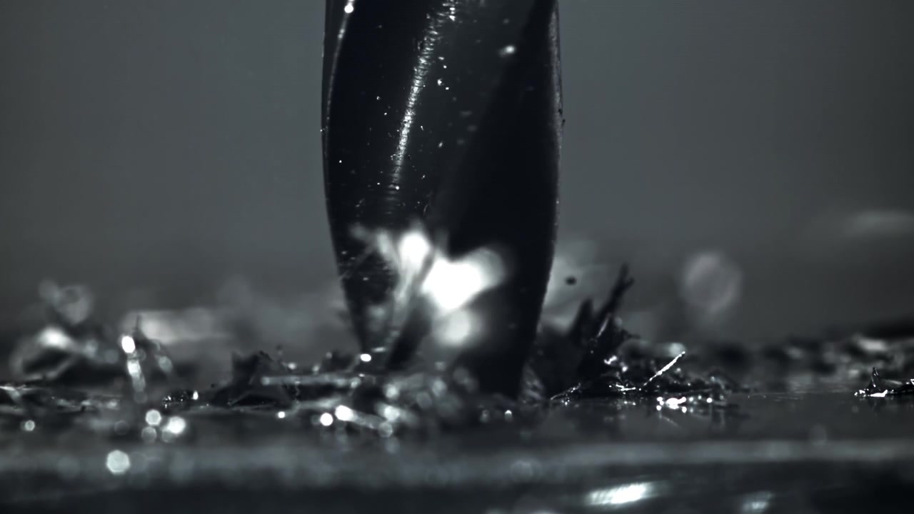 Slow Motion Close-Up of a Drill Bit Cutting Metal