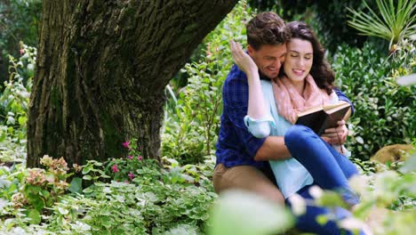 romantic couple reading novel in park