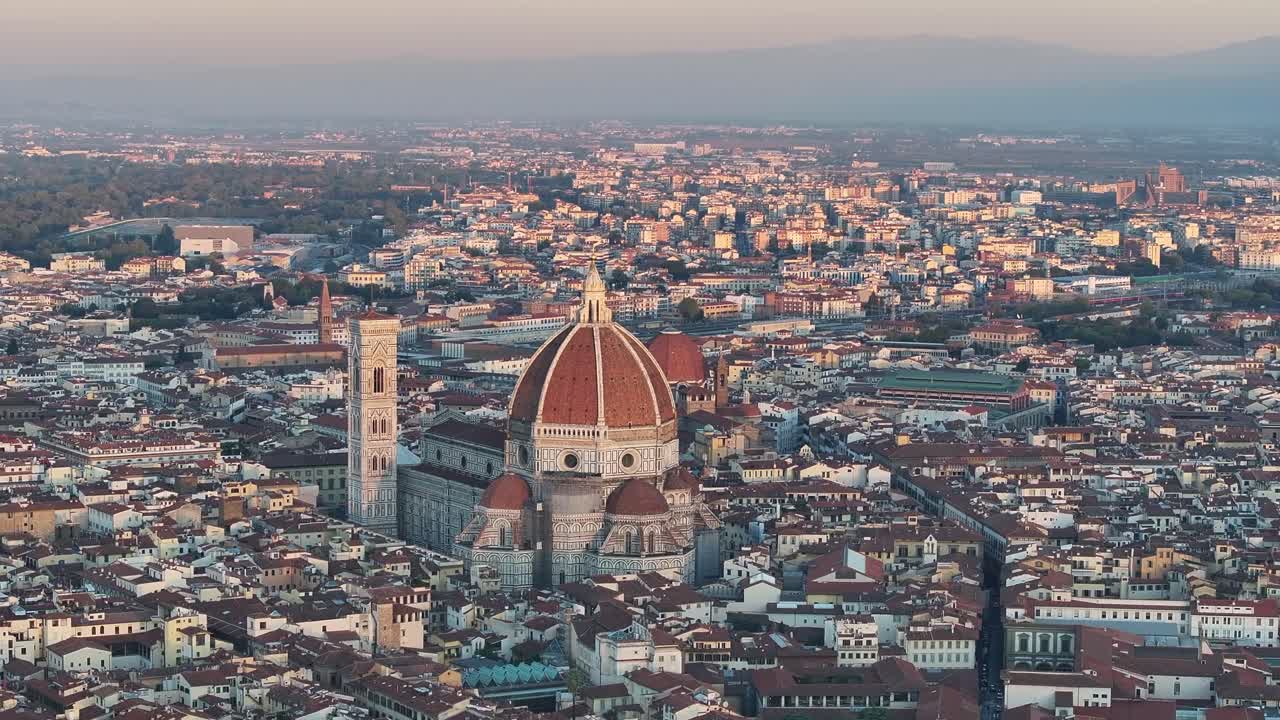 Wide, layered view of the beautiful Tuscan countryside, showing rolling hills, cypress trees, and farmhouses shrouded in morning mist and fog