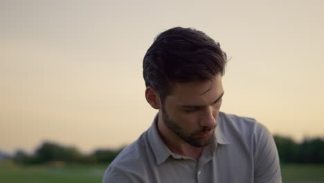 handsome man celebrate successful golf game on sunset nature fairway course.