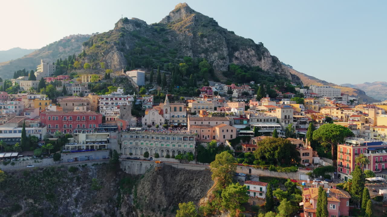 Scenic view of Taormina, Sicily, with mountains and historic buildings