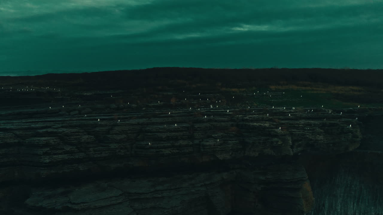 Dramatic Ocean Waves Crashing Against Rocky Cliffs with Flying Seagulls