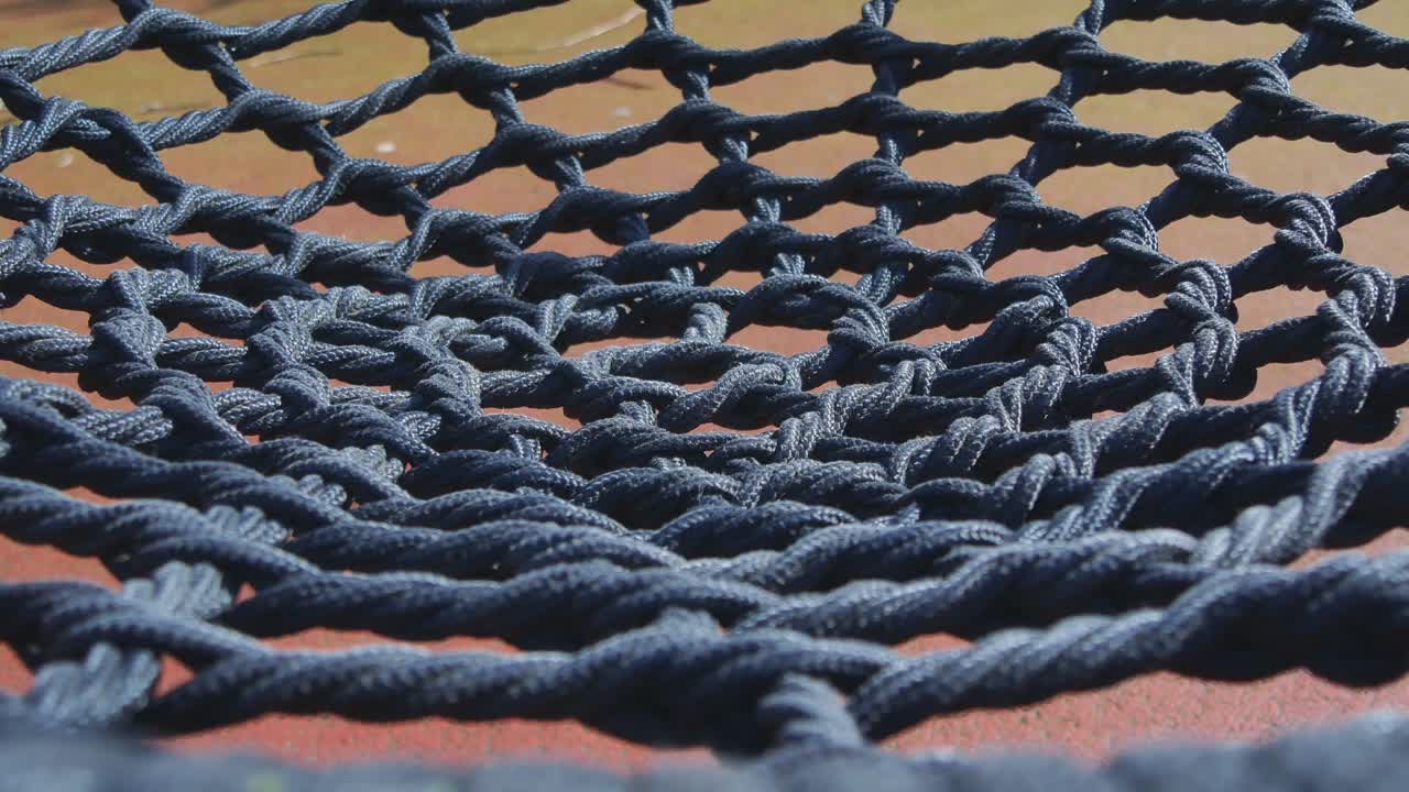 Rope Net Swings In An Empty Children's Playground