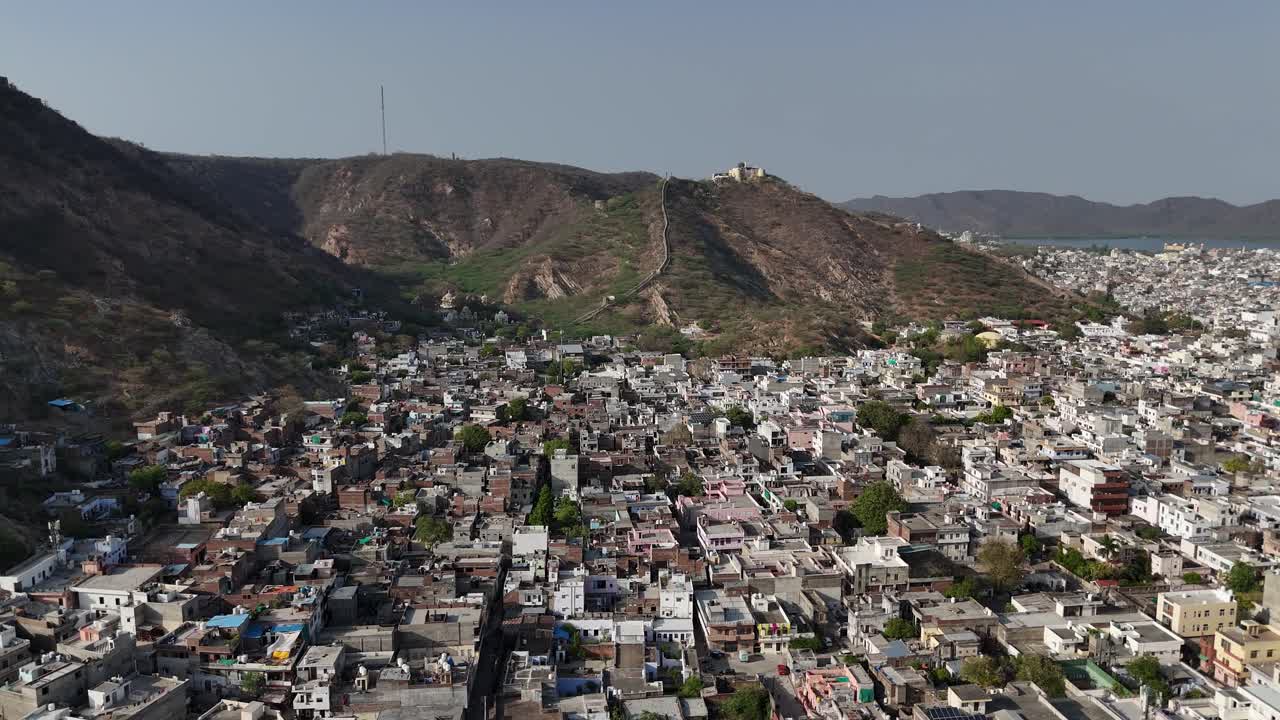 Scenic drone shot of a sprawling fort wall snaking through the hills.