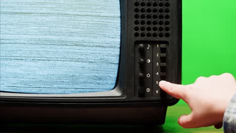 retro style tv set with green screen chroma key background, vintage 60s analog television with grain and noise.