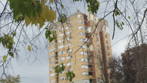 low angle view of tall residential building skyscraper, example of brutalist architecture, establishing shot