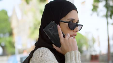 Woman-in-hijab-talking-on-mobile-phone-4k