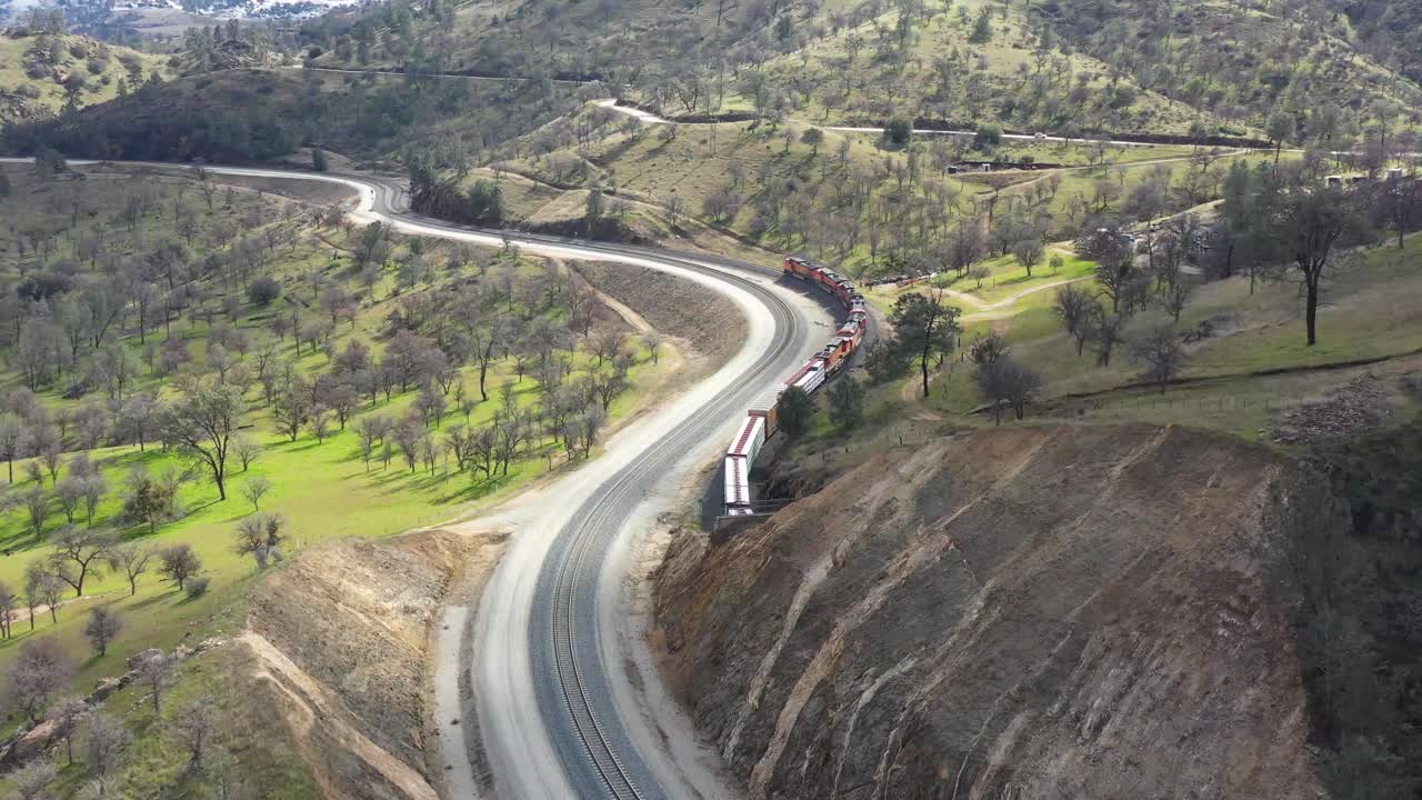 Drone BNSF Train coming out a tunnel at the Tehachapi Loop tunnel