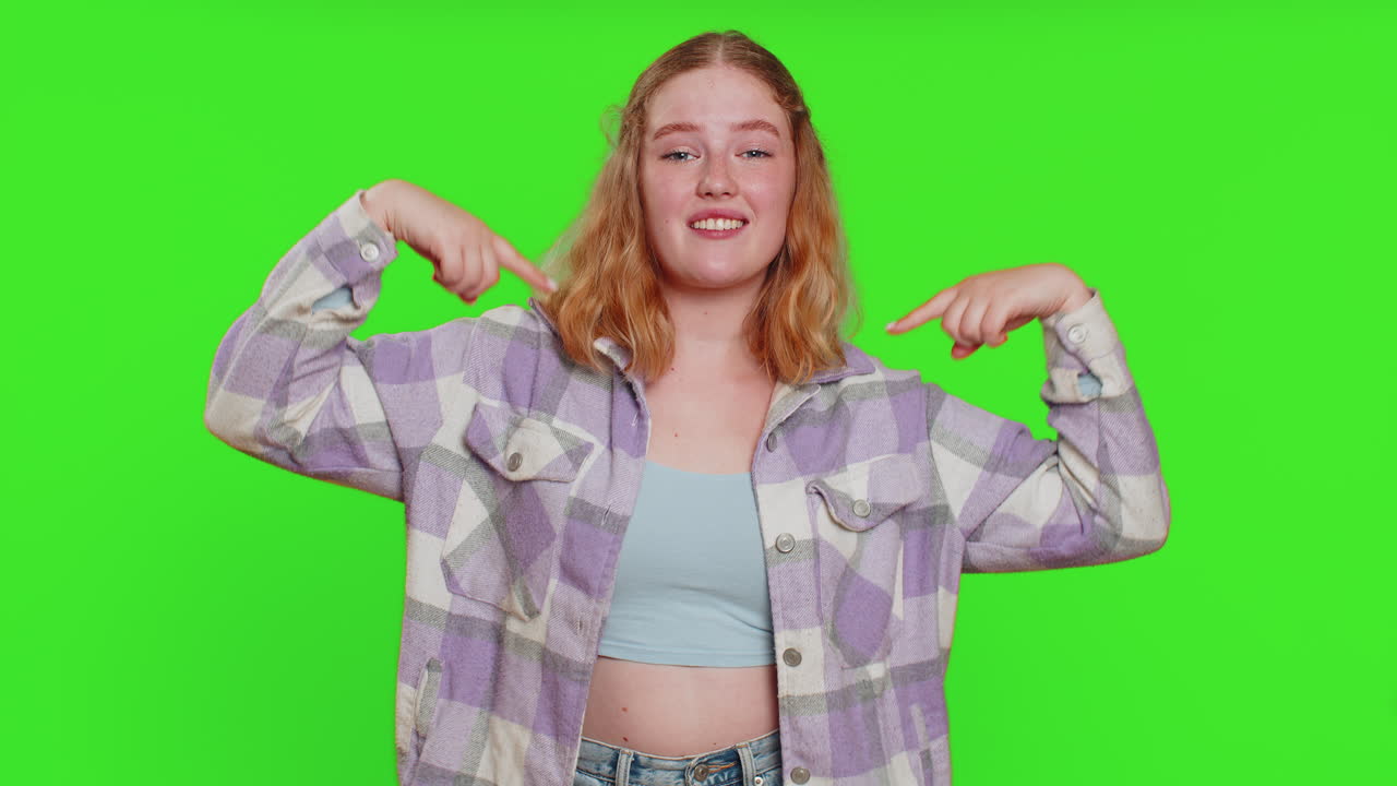 Young woman feeling very proud pointing herself overjoyed by success making choice selfconfident