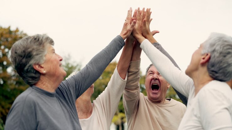 High five, support and a group of senior friends