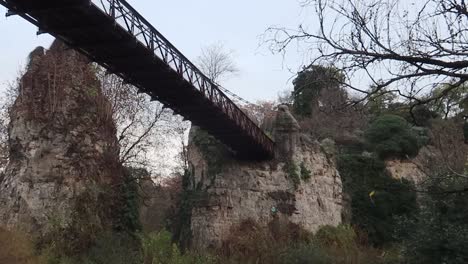 bridge in the buttes-chaumont park in paris, viewed from under in grey weather