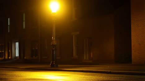 empty street at night with glowing street light reflection