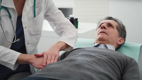 Handheld-video-shows-of-doctor-examining-stomach-of-senior-man
