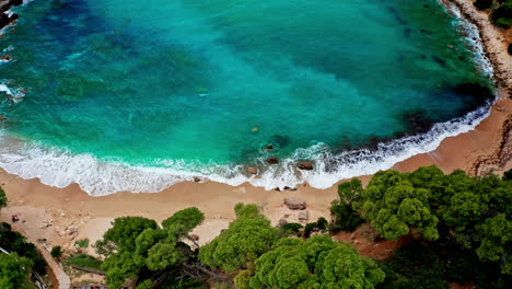 Aerial-drone-shot-of-Greek-Landscape-with-Turquoise-Sea-or-Ocean-Bay-and-Empty-Sand-Beach