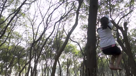 a sporty gymnast performs exercises with a rope in sportswear