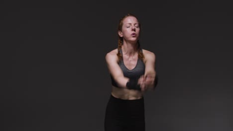 Studio-Shot-Of-Mature-Woman-Wearing-Gym-Fitness-Clothing-Doing-Mountain-Climber-Exercise-1