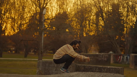 man jumping in park at sunset