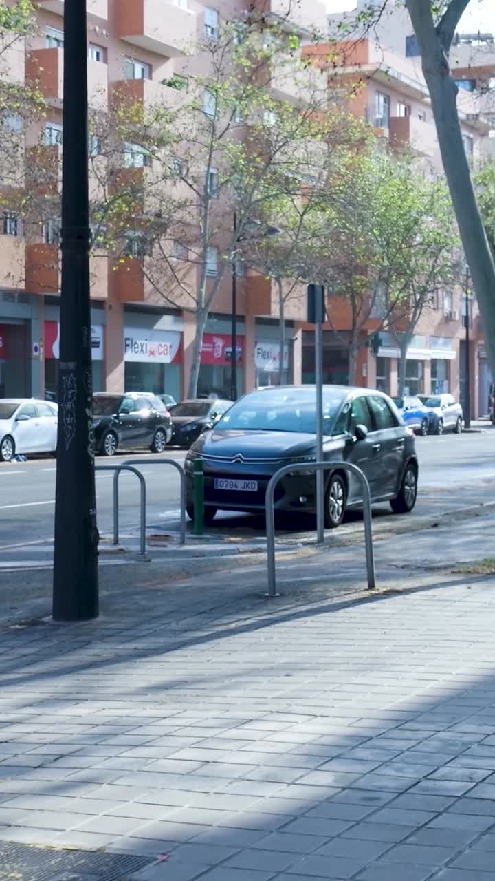 City street scene with parked cars and motorcycles