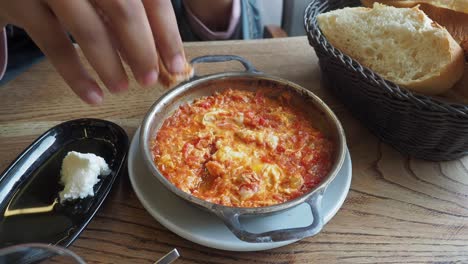 person eating menemen