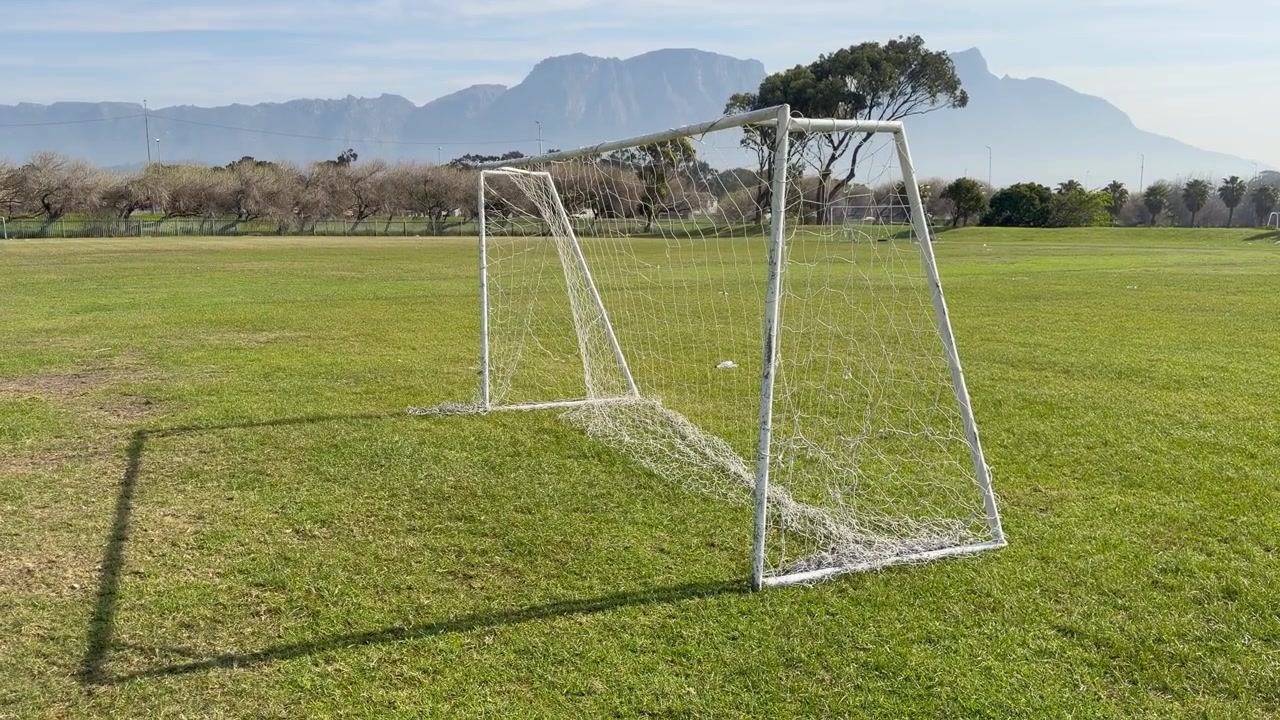 An abandoned football field with football goals.