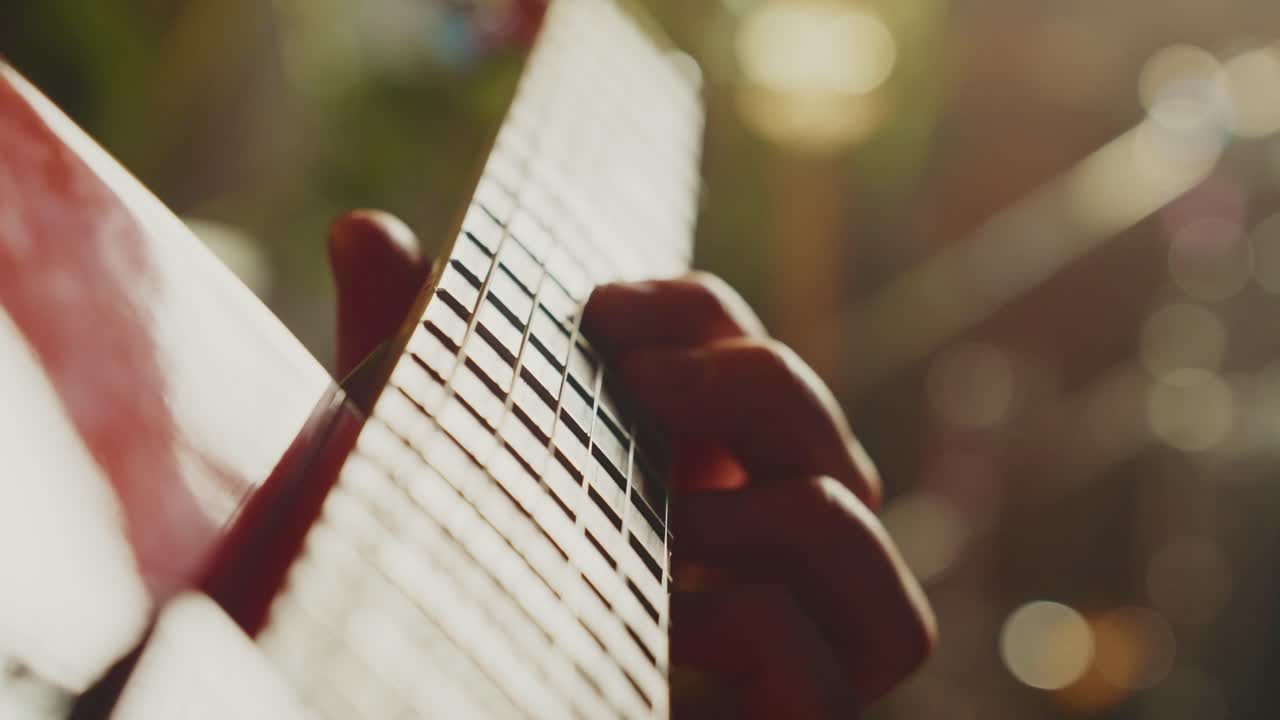 Close-up of a person playing guitar