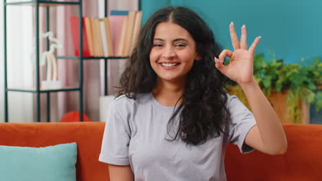 Happy-cheerful-Indian-woman-looking-approvingly-at-camera-showing-ok-gesture,-positive-like-sign