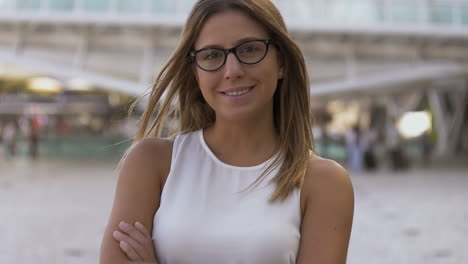 Attractive-businesswoman-smiling-at-camera-on-street