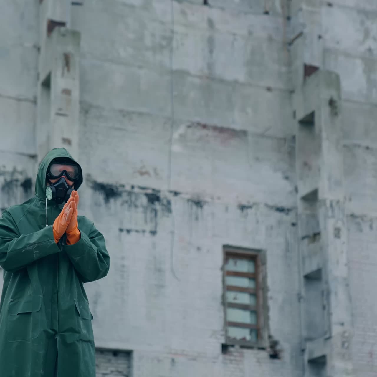 Human in gas mask among ruins. Man walking around in the post apocalyptic and ruined city