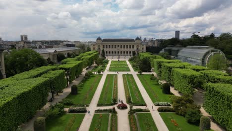 People-in-Jardin-des-Plantes-or-Garden-of-Plants-with-Gallery-of-Evolution-in-background,-Paris,-France