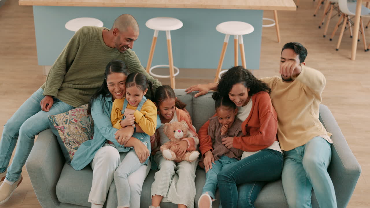 Above, hug and big family on the home sofa
