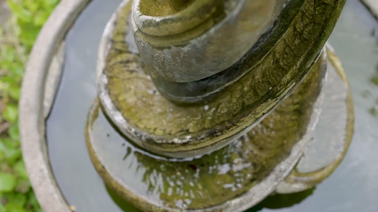 A close up shot of water streaming down from a fountain.
