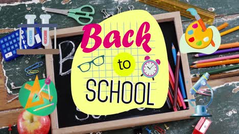 Back-to-school-text-against-wooden-slate-and-school-equipment-on-wooden-table