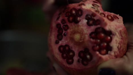 Woman-peeling-pomegranate-with-knife