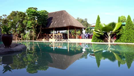 Captivating-establishing-scene-showcases-a-luxurious-hotel-nestled-amidst-the-Rwandan-landscape,-featuring-charming-huts-that-exude-a-sense-of-comfort-and-luxury